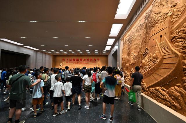 People visit the memorial site of the full outbreak of the Chinese People's War of Resistance Against Japanese Aggression in Beijing on July 12, 2025. China's government on July 7, marks the 80th anniversary of the end of China's War of Resistance Against Japanese Aggression. (Photo by Adek BERRY / AFP)
