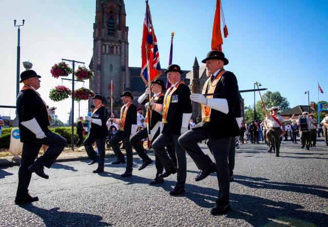 Members of Orange Order take part in a parade in Belfast on July 12, 2025, to celebrate the battle of the Boyne in 1690, when the Protestant King William of Orange defeated the Catholic King James. (Photo by PAUL FAITH / AFP)