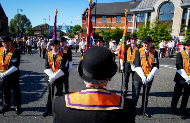 Members of Orange Order take part in a parade in Belfast on July 12, 2025, to celebrate the battle of the Boyne in 1690, when the Protestant King William of Orange defeated the Catholic King James. (Photo by PAUL FAITH / AFP)