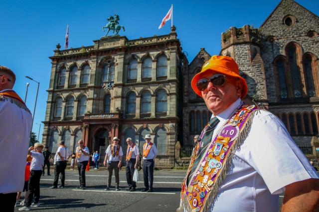 A member of Orange Order waits to take part in a parade in Belfast on July 12, 2025, to celebrate the battle of the Boyne in 1690, when the Protestant King William of Orange defeated the Catholic King James. (Photo by PAUL FAITH / AFP)