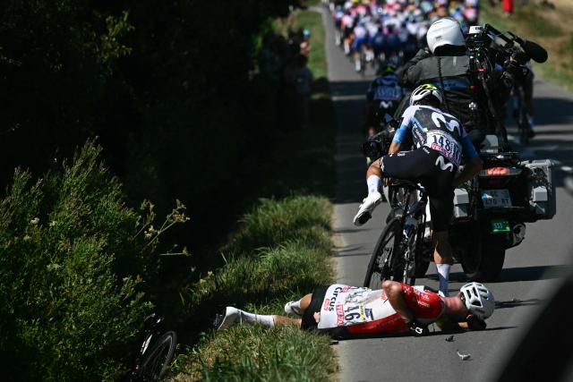 Intermarch - Wanty team's German rider Jonas Rutsch lies of the ground injured after suffering a crash at the back of the pack of riders (peloton) during the 8th stage of the 112th edition of the Tour de France cycling race, 171.4 km between Saint-Meen-le-Grand and Laval Espace Mayenne, western France, on July 12, 2025. (Photo by Loic VENANCE / AFP)