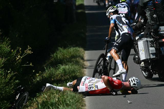 Intermarch - Wanty team's German rider Jonas Rutsch lies of the ground injured after suffering a crash at the back of the pack of riders (peloton) during the 8th stage of the 112th edition of the Tour de France cycling race, 171.4 km between Saint-Meen-le-Grand and Laval Espace Mayenne, western France, on July 12, 2025. (Photo by Loic VENANCE / AFP)