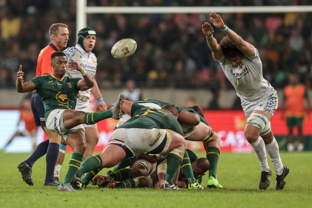 South Africa's scrum-half Grant Williams (L) kicks the ball during the international rugby union Test match between South Africa and Italy at Nelson Mandela Bay Stadium in Gqeberha on July 12, 2025. (Photo by PHILL MAGAKOE / AFP)