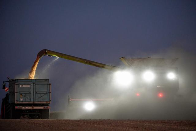 A French farmer drives his 10.80-meter-wide tracked combine harvester and harvests "Sherk," a soft wheat variety, about ten days earlier in the season in Marbois, near Dreux, central France, on July 11, 2025. (Photo by JEAN-FRANCOIS MONIER / AFP)