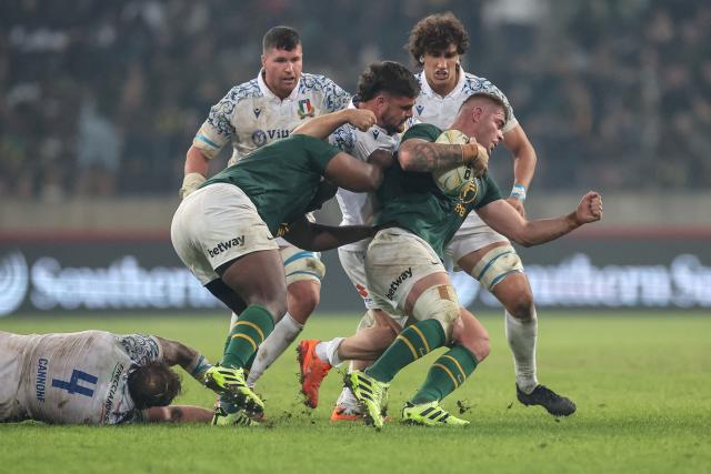 South Africa's Malcolm Marx (R) runs with the ball during the international rugby union Test match between South Africa and Italy at Nelson Mandela Bay Stadium in Gqeberha on July 12, 2025. (Photo by PHILL MAGAKOE / AFP)