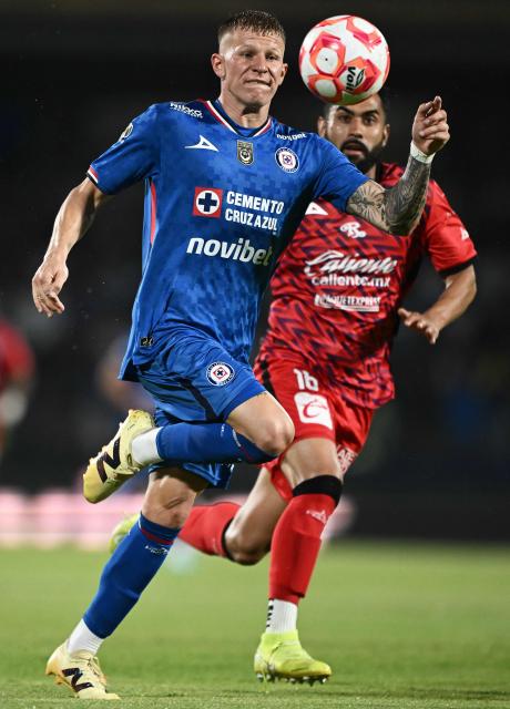 Cruz Azul’s midfielder #07 Mateusz Bogusz (L) and Mazatlбn’s midfielder #16 Jose Joaquin Esquivel (R) vie for the ball during the Liga MX Clausura football tournament match between Cruz Azul and Mazatlan at the  Estadio Olнmpico Universitario Stadium in Mexico City on July 12, 2025. (Photo by Carl de Souza / AFP)