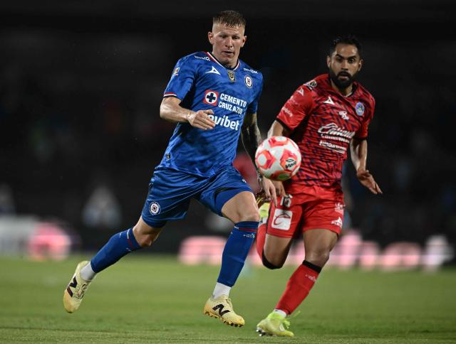 Cruz Azul’s midfielder #07 Mateusz Bogusz (L) and Mazatlбn’s midfielder #16 Jose Joaquin Esquivel (R) vie for the ball during the Liga MX Clausura football tournament match between Cruz Azul and Mazatlan at the  Estadio Olнmpico Universitario Stadium in Mexico City on July 12, 2025. (Photo by Carl de Souza / AFP)
