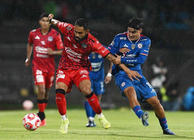 Cruz Azul’s forward #18 Luka Romero (R) and Mazatlбn’s midfielder #16 Jose Joaquin Esquivel (L) vie for the ball during the Liga MX Clausura football tournament match between Cruz Azul and Mazatlan at the  Estadio Olнmpico Universitario Stadium in Mexico City on July 12, 2025. (Photo by Carl de Souza / AFP)