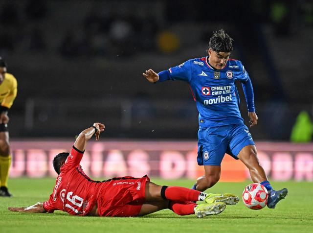 Cruz Azul’s #18 Luka Romero (R) vies for the ball with Mazatlan’s #16 Jose Esquivel (L) during the Liga MX Clausura football tournament match between Cruz Azul and Mazatlan at the  Estadio Olнmpico Universitario Stadium in Mexico City on July 12, 2025. (Photo by Carl de Souza / AFP)