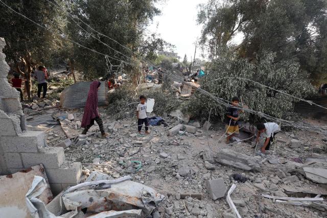 Palestinians assess the damage in the aftermath of an overnight Israeli strike that hit Nuseirat in the central Gaza Strip on July 13, 2025. (Photo by Eyad BABA / AFP)