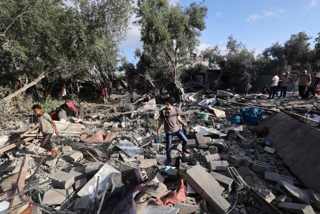 Palestinians assess the damage in the aftermath of an overnight Israeli strike that hit Nuseirat in the central Gaza Strip on July 13, 2025. (Photo by Eyad BABA / AFP)