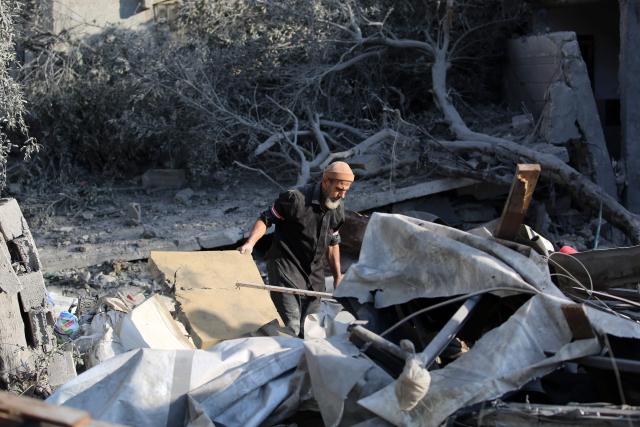 A Palestinian man checks the damage in the aftermath of an overnight Israeli strike that hit Nuseirat in the central Gaza Strip on July 13, 2025. (Photo by Eyad BABA / AFP)
