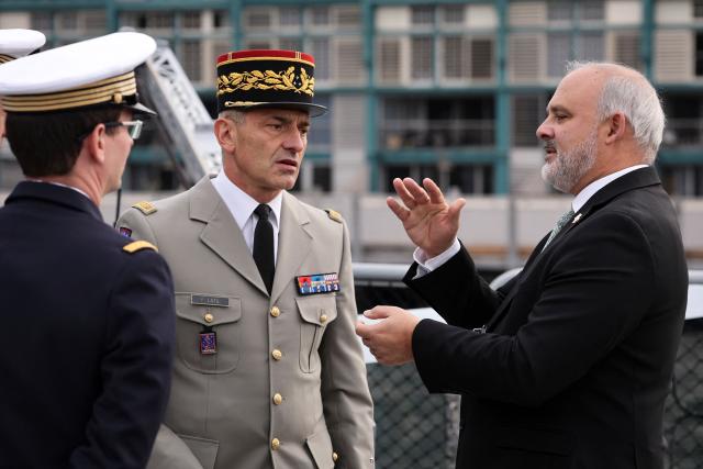 Commander of French Forces New Caledonia Major General Yann Latil (C) speaks with French Ambassador to Australia Pierre-André Imbert (R) aboard the French patrol vessel Auguste Benebig, which will participate in the annual Talisman Sabre exercise, in Sydney on July 13, 2025. France's defence relations with Australia have recovered after their 2021 bust-up over a major submarine contract, the country's ambassador said Sunday. Paris expressed its "strong regrets" at the time when Australia tore up its multibillion-dollar deal with France, Ambassador Imbert said. (Photo by DAVID GRAY / AFP)