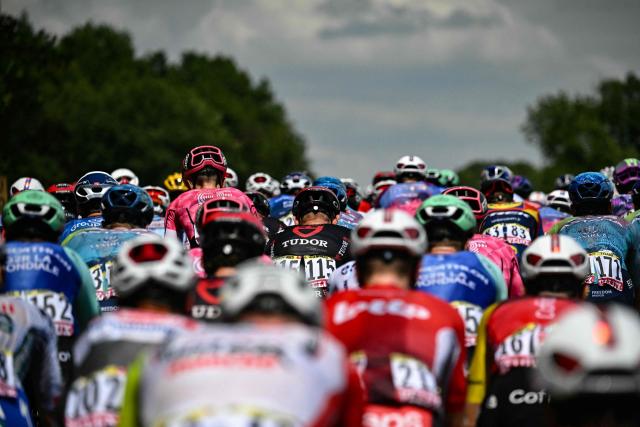 The pack of riders (peloton) cycles during the 9th stage of the 112th edition of the Tour de France cycling race, 174.1 km between Chinon and Chateauroux, central France, on July 13, 2025. (Photo by Loic VENANCE / AFP)