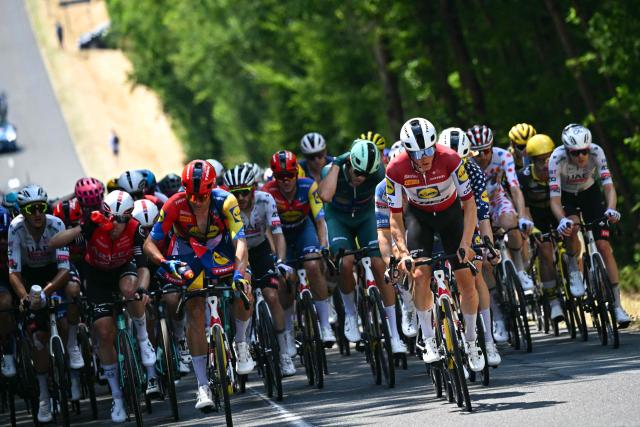 Lidl - Trek team's Latvian rider Toms Skujins (C) cycles with the pack of riders (peloton) during the 9th stage of the 112th edition of the Tour de France cycling race, 174.1 km between Chinon and Chateauroux, central France, on July 13, 2025. (Photo by Loic VENANCE / AFP)