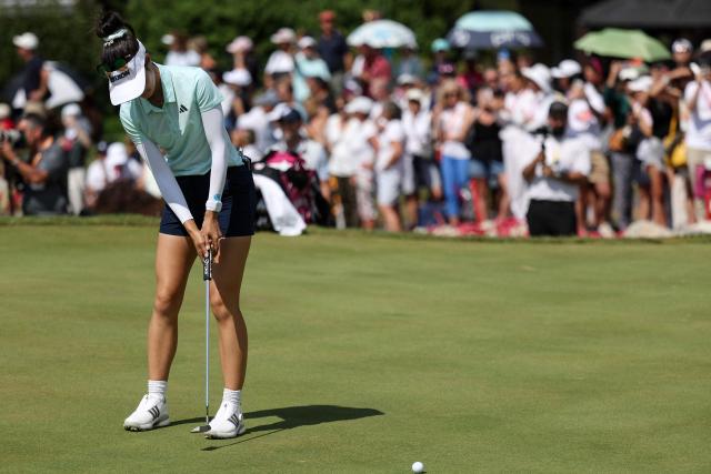 Australia's Grace Kim makes her final putt for victory on the first playoff hole after the final round of the Amundi Evian Championship at Evian Resort Golf Club, in Evian-Les-Bains, eastern France on July 13, 2025. (Photo by Alex MARTIN / AFP)