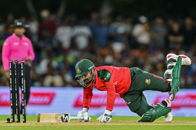 Bangladesh's captain Litton Das dives to reach the crease during the second Twenty20 international cricket match between Sri Lanka and Bangladesh at the Rangiri Dambulla International Stadium in Dambulla on July 13, 2025. (Photo by Ishara S. KODIKARA / AFP)