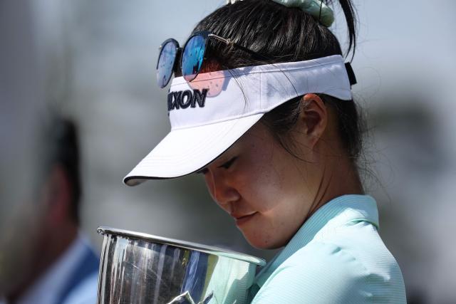 Australia's Grace Kim holds the trophy as she celebrates after victory on the first playoff hole after the final round of the Amundi Evian Championship at Evian Resort Golf Club, in Evian-Les-Bains, eastern France on July 13, 2025. (Photo by Alex MARTIN / AFP)