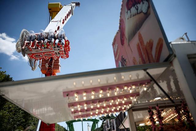 Visitors enjoy a fairground ride at the funfair setup in the Jardin des Tuileries garden
in central Paris on July 13, 2025. (Photo by Guillaume BAPTISTE / AFP)