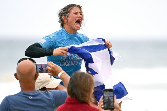 Israel's surfer Anat Lelior reacts after winning the final of the Lacanau Pro World Surf League (WSL) event along the Atlantic Ocean in Lacanau, south-western France on July 13, 2025. For nearly fifty years, the Lacanau Pro has withstood all the upheavals in the surf industry to become the last major international gathering in mainland France. (Photo by Christophe ARCHAMBAULT / AFP)