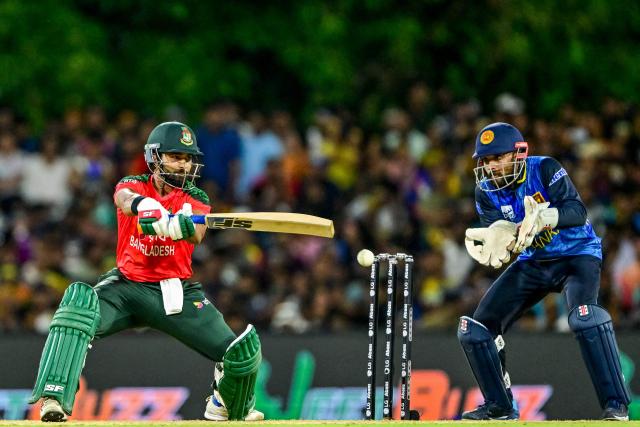 Bangladesh's Shamim Hossain (L) plays a shot during the second Twenty20 international cricket match between Sri Lanka and Bangladesh at the Rangiri Dambulla International Stadium in Dambulla on July 13, 2025. (Photo by Ishara S. KODIKARA / AFP)