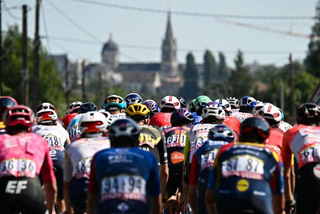 The pack of riders (peloton) nears Chateauroux during the 9th stage of the 112th edition of the Tour de France cycling race, 174.1 km between Chinon and Chateauroux, central France, on July 13, 2025. (Photo by Loic VENANCE / AFP)
