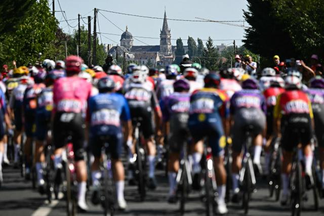 The pack of riders (peloton) nears Chateauroux during the 9th stage of the 112th edition of the Tour de France cycling race, 174.1 km between Chinon and Chateauroux, central France, on July 13, 2025. (Photo by Loic VENANCE / AFP)