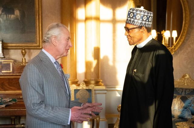 (FILES) Britain's King Charles III (L) receives President of Nigeria Muhammadu Buhari during an audience at Buckingham Palace, in London on November 9, 2022. Former Nigerian president Muhammadu Buhari -- who led his country first as a military strongman and later as an elected democrat -- died Sunday at the age of 82, an aide said. (Photo by Stefan Rousseau / WPA Rota / AFP)