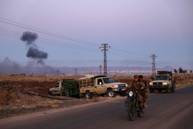 Smoke billows following Israeli strikes in the distance as members of Syria's security forces man rocket launchers in an area between Mazraa and Walga near the predominantly Druze city of Sweida on July 14, 2025, following clashes between Bedouin tribes and Druze fighters. Israeli Defence Minister Israel Katz issued a warning to Damascus on July 14 after the military struck several tanks in southern Syria to prevent them from reaching a Druze village near the scene of sectarian clashes. (Photo by Bakr ALKASEM / AFP)