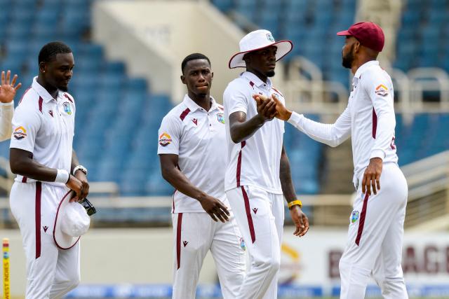 Roston Chase (R) of West Indies congratulates Alzarri Joseph (2R), Shamar Joseph (2L) and Jayden Seales (L) for bowling out Australia during the third day of the third Test cricket match between West Indies and Australia at Sabina Park in Kingston, Jamaica, on July 14, 2025. (Photo by Randy Brooks / AFP)
