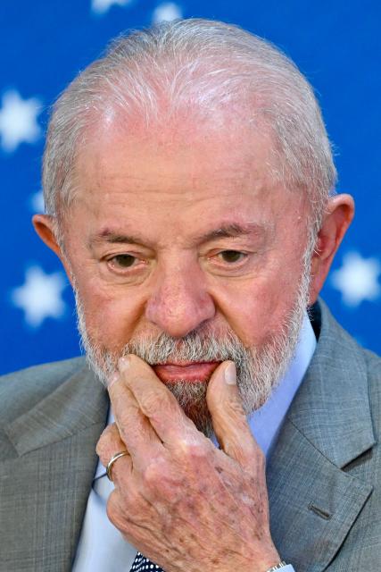 Brazilian President Luis Inacio Lula da Silva gestures during the launch of a program to support taxi drivers at Planalto Palace in Brasilia on July 14, 2025. Luis Inácio Lula da Silva instructed his vice president and minister of industry and trade, Geraldo Alckmin, to form a commission with the sectors most affected by the 50% tariffs imposed by US President Donald Trump to negotiate with the US government in an attempt to prevent the tariffs from coming into effect on August 1. (Photo by EVARISTO SA / AFP)