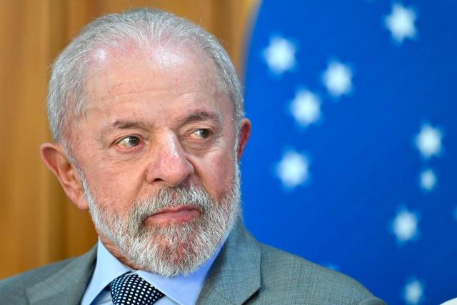 Brazilian President Luis Inacio Lula da Silva looks on during the launch of a program to support taxi drivers at Planalto Palace in Brasilia on July 14, 2025. Luis Inácio Lula da Silva instructed his vice president and minister of industry and trade, Geraldo Alckmin, to form a commission with the sectors most affected by the 50% tariffs imposed by US President Donald Trump to negotiate with the US government in an attempt to prevent the tariffs from coming into effect on August 1. (Photo by EVARISTO SA / AFP)