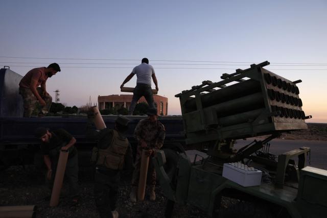 Members of Syria's security forces load a rocket launcher near the predominantly Druze city of Sweida on July 14, 2025, following clashes between Bedouin tribes and Druze fighters. Israeli Defence Minister Israel Katz issued a warning to Damascus on July 14 after the military struck several tanks in southern Syria to prevent them from reaching a Druze village near the scene of sectarian clashes. (Photo by Bakr ALKASEM / AFP)