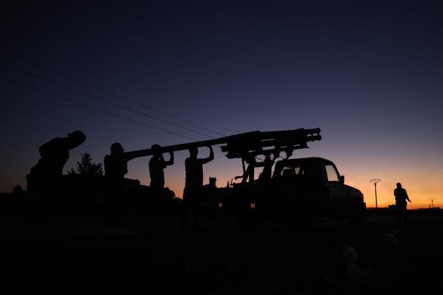 Members of Syria's security forces load a rocket launcher near the predominantly Druze city of Sweida on July 14, 2025, following clashes between Bedouin tribes and Druze fighters. Israeli Defence Minister Israel Katz issued a warning to Damascus on July 14 after the military struck several tanks in southern Syria to prevent them from reaching a Druze village near the scene of sectarian clashes. (Photo by Bakr ALKASEM / AFP)