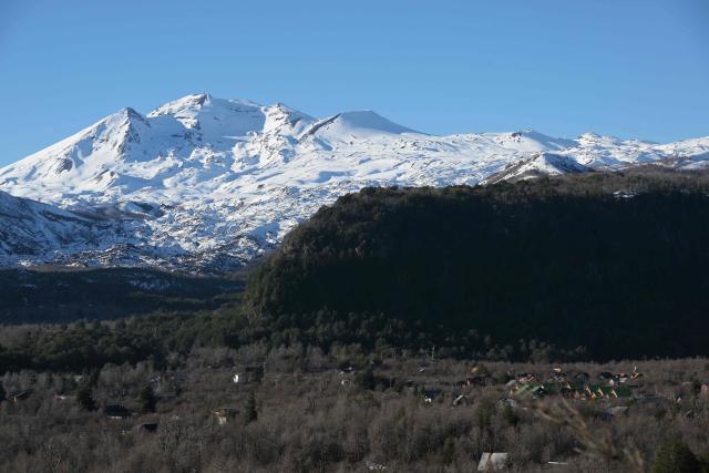 View of the volcanoes Chillan Viejo and Chillan Nuevo, from the town of Las Trancas in the Ñuble region, Chile, on July 9, 2025. (Photo by RODRIGO ARANGUA / AFP)