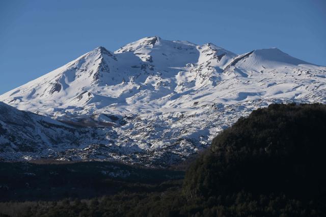 View of the volcanoes Chillan Viejo and Chillan Nuevo, from the town of Las Trancas in the Ñuble region, Chile, on July 9, 2025. (Photo by RODRIGO ARANGUA / AFP)