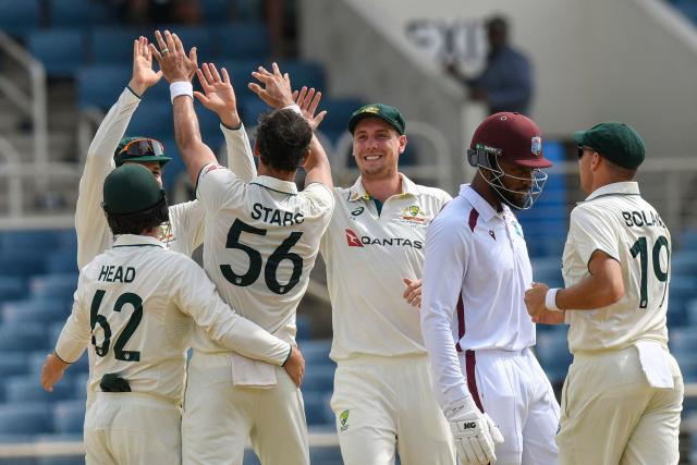 Mikyle Louis (2R) of West Indies walks off the field dismissed by Mitchell Starc (2L) of Australia during the third day of the third Test cricket match between West Indies and Australia at Sabina Park in Kingston, Jamaica, on July 14, 2025. (Photo by Randy Brooks / AFP)