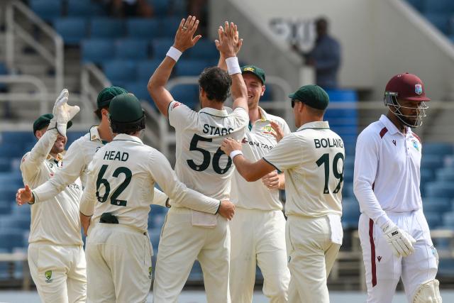 Mikyle Louis (R) of West Indies walks off the field dismissed by Mitchell Starc (C) of Australia during the third day of the third Test cricket match between West Indies and Australia at Sabina Park in Kingston, Jamaica, on July 14, 2025. (Photo by Randy Brooks / AFP)