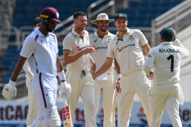 Josh Hazlewood (2L), Mitchell Starc (3L) and Cameron Green (2R) of Australia celebrate the dismissal of Roston Chase (L) of West Indies during the third day of the third Test cricket match between West Indies and Australia at Sabina Park in Kingston, Jamaica, on July 14, 2025. (Photo by Randy Brooks / AFP)