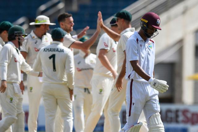 Roston Chase (R) of West Indies walks off the field dismissed by Josh Hazlewood (3R) of Australia during the third day of the third Test cricket match between West Indies and Australia at Sabina Park in Kingston, Jamaica, on July 14, 2025. (Photo by Randy Brooks / AFP)