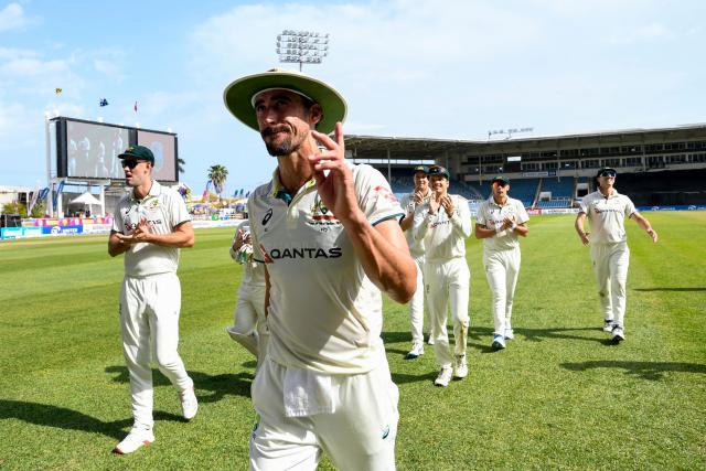 Mitchell Starc (2L) of Australia walks off the field waving to supporters  during the third day of the third Test cricket match between West Indies and Australia at Sabina Park in Kingston, Jamaica, on July 14, 2025. (Photo by Randy Brooks / AFP)