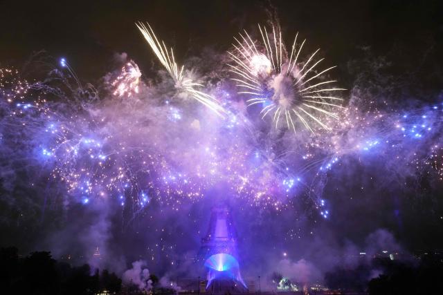 Fireworks light up around the Eiffel Tower during a choreographed firework and drone show to celebrate Bastille Day, in Paris, on July 14, 2025. (Photo by Dimitar DILKOFF / AFP)