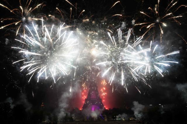 Fireworks light up around the Eiffel Tower during a choreographed firework and drone show to celebrate Bastille Day, in Paris, on July 14, 2025. (Photo by Dimitar DILKOFF / AFP)