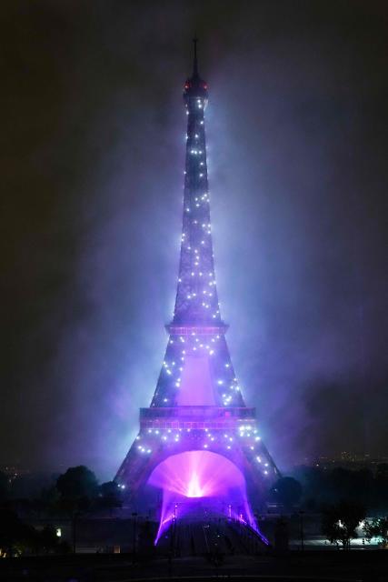 TOPSHOT - Drones light up around the Eiffel Tower during a choreographed firework and drone show to celebrate Bastille Day, in Paris, on July 14, 2025. (Photo by Dimitar DILKOFF / AFP)