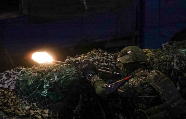 A soldier fires his weapon during Taiwan's annual Han Kuang military exercises in Taipei on July 15, 2025. (Photo by I-Hwa Cheng / AFP)