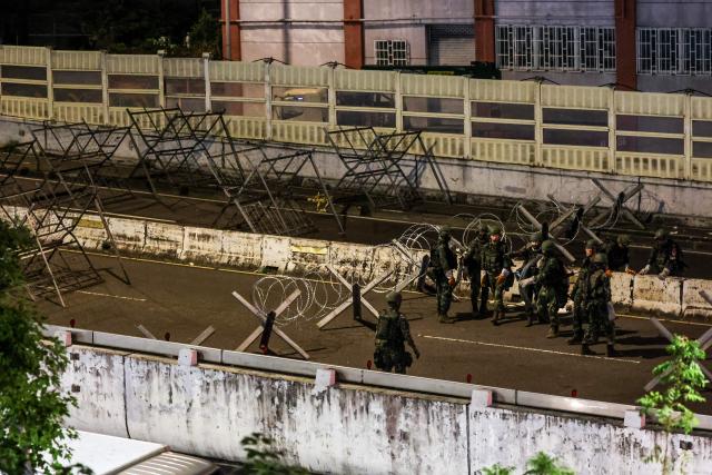 Soldier build up blocks on a bridge connecting New Taipei with Taiwan's capital Taipei during the annual Han Kuang military exercises in Taipei on July 15, 2025. (Photo by I-Hwa Cheng / AFP)