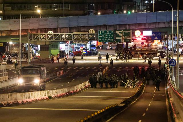 Soldier build up blocks on a bridge connecting New Taipei with Taiwan's capital Taipei during the annual Han Kuang military exercises in Taipei on July 15, 2025. (Photo by I-Hwa Cheng / AFP)