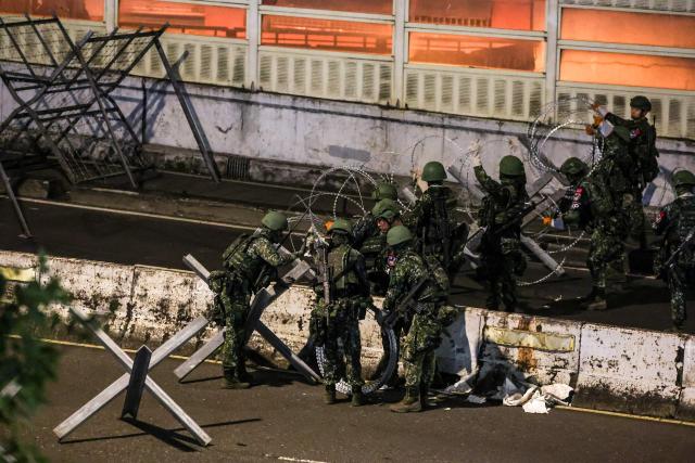 Soldier build up blocks on a bridge connecting New Taipei with Taiwan's capital Taipei during the annual Han Kuang military exercises in Taipei on July 15, 2025. (Photo by I-Hwa Cheng / AFP)