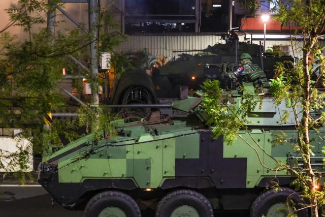 Soldiers riding a CM-34 Clouded Leopard, officially Taiwan Infantry Fighting Vehicle (TIFV), take part in the annual Han Kuang military exercises in Taipei on July 15, 2025. (Photo by I-Hwa Cheng / AFP)