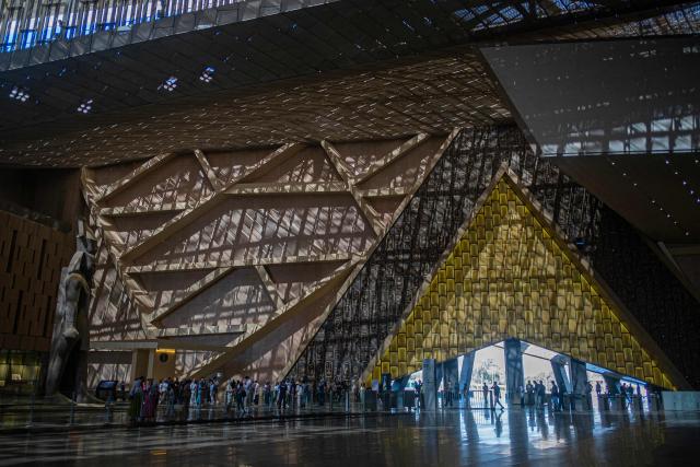 (FILES) Visitors tour the Grand Egyptian Museum in Giza on the southwestern outskirts of the capital Cairo on May 5, 2025. The museum was expected to attract up to five million visitors annually, fuelling optimism across Cairo's battered tourism sector. But less than three weeks before its July 3 opening, the government announced another delay, this time pushing the landmark event to the final quarter of the year. (Photo by Khaled DESOUKI / AFP)